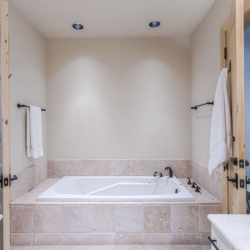 Jack & Jill bathroom shared with Bedroom 3 & 4, Stand-alone shower & jetted bathtub, two sinks.