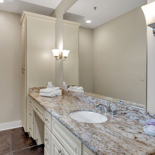 Granite vanity with elegant sconce lighting