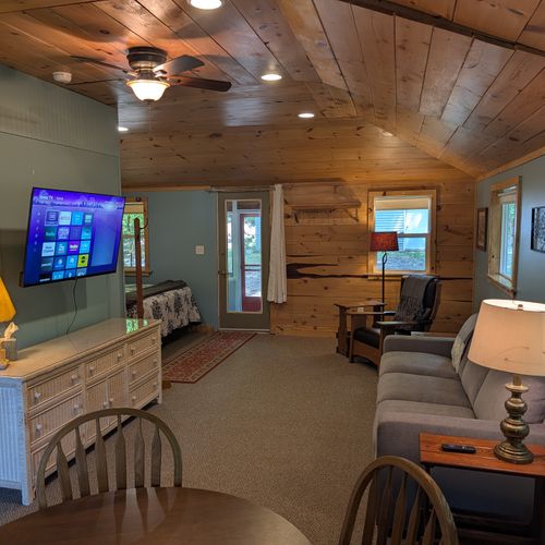 OVERVIEW: The interior view of the cute living room facing towards the comfy queen bed on the left. The smart TV and couch make for a perfect spot to sit back and relax!