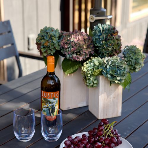 The dining area on the main house deck is perfect for long, easy afternoons looking over the meadow.