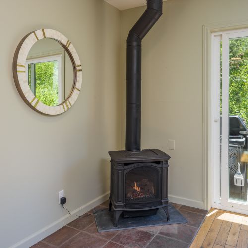 Warm up by the fireplace while enjoying views of the surrounding forest.