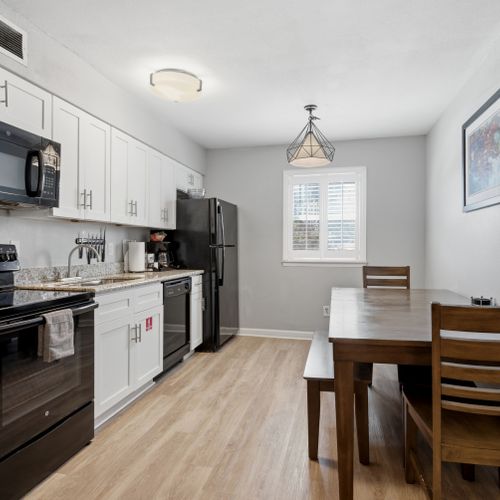 Sleek kitchen w/ modern appliances & a dining area ready for every meal.