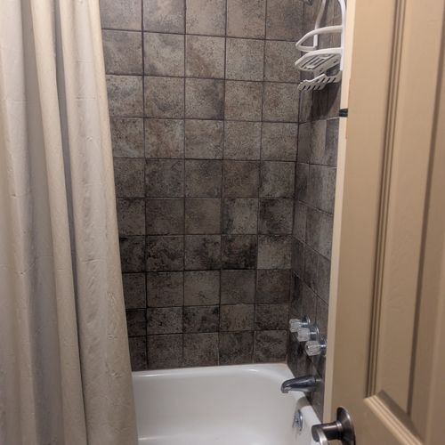 BATHROOM:  Includes combination tub / shower and toilet.  (Note that there is no vanity, sink, or mirror in the bathroom.)