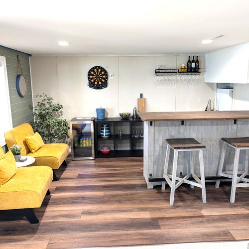 RECREATION ROOM (LOWER LEVEL):  The home has a very cute and fun recreation room in the lower level that is complete with a wet bar and mini-frig.
