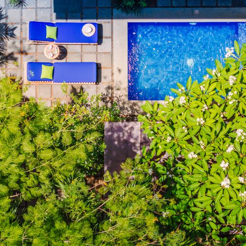 Aerial pool view at this Langosta rental near Tamarindo. Private tropical oasis with lush gardens, sun loungers, and outdoor dining. Perfect home base for surf trips, beach days, and coastal relaxation.