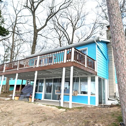 EXTERIOR:  The back of the house, highlighting the large deck and lower level patio