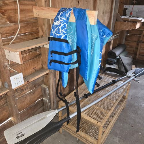 EXTERIOR:  The paddles and life jackets for the kayaks.