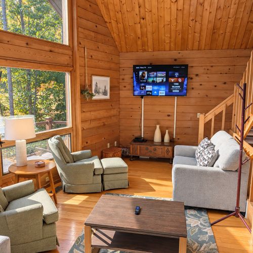 LIVING ROOM (SECOND FLOOR):  The home has a gorgeous living room with a sofa, loveseat, chairs, coffee table, and large screen television.