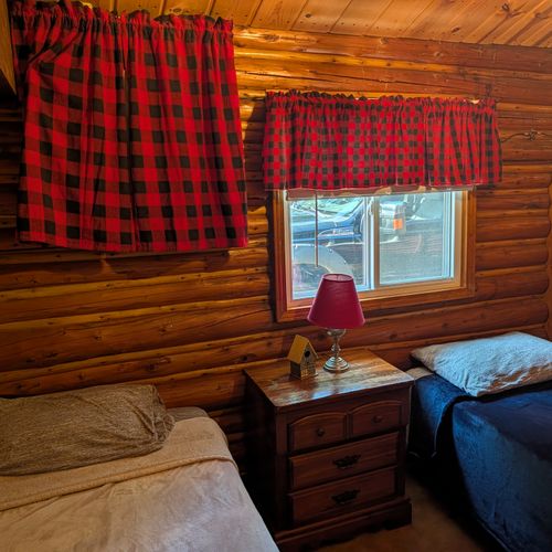 BEDROOM #2:  Features 2 twin size beds, nightstand, lamp, closet, dresser, and luggage stand
