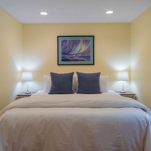 Unwind in this inviting king bedroom featuring plush bedding, soft lighting, and a peaceful atmosphere—perfect for a restful night's sleep after a day exploring Orcas Island.