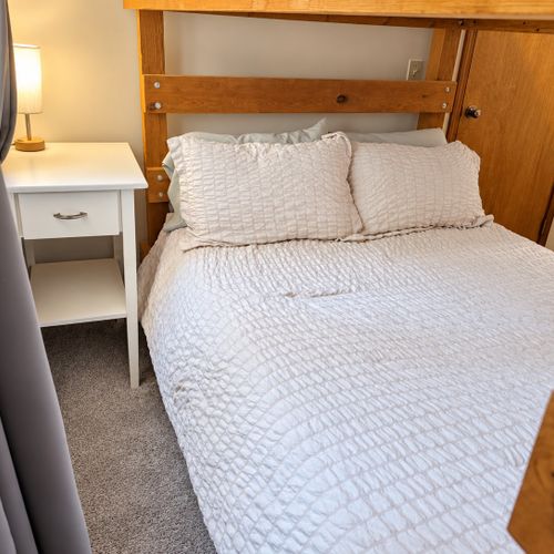BEDROOM #2 (FIRST FLOOR):  Features a twin-on-twin bunk bed, nightstand, closet, dresser, and mirror.