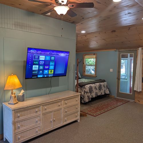 LIVING ROOM: The living room which offers a smart TV and a comfy queen bed