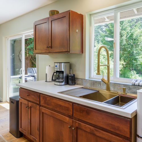 Thoughtfully designed kitchen featuring modern amenities and peaceful woodland views