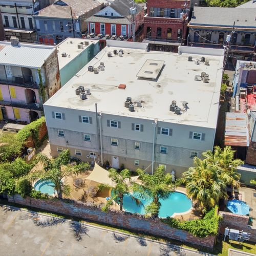Bird's-eye view of the pool & hot tub framed by the city skyline.