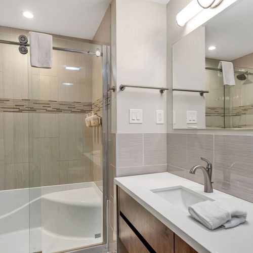 Glass shower with sleek tile finishes