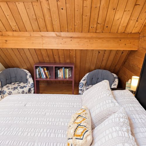 LOFT (THIRD FLOOR):  The home has a very cute top floor loft area with a king size bed, fold-out bed, chairs, nightstands, lamps, mirror, dresser, clothing rack, and a television.