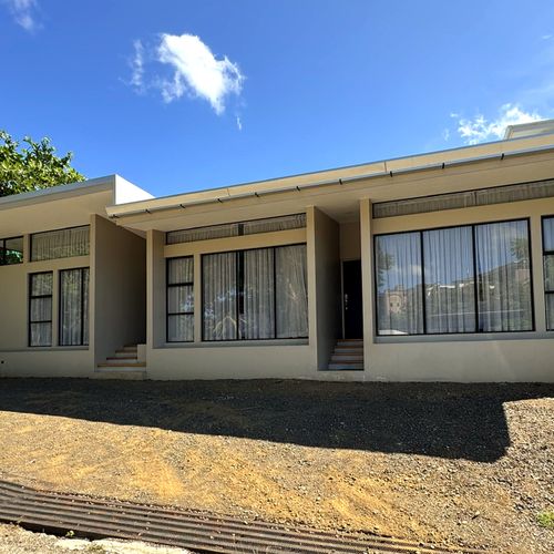 Street-level exterior of Casa Margarita, a single-story villa in Tamarindo, Costa Rica, showing the private entrance (left) to the apartment with covered entrance.