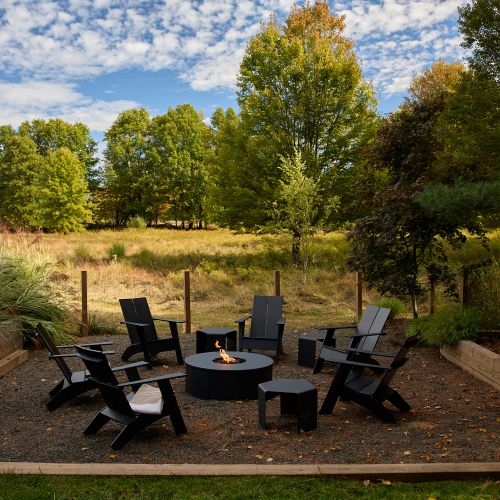 The propane fire pit, steps from the pool and surrounded by 5 private acres.