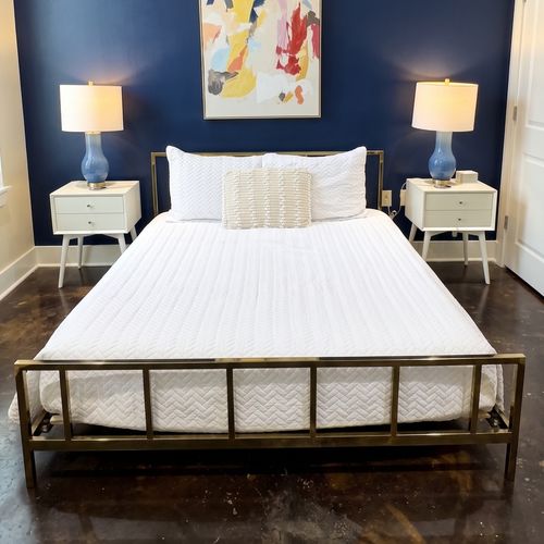 Bright bedroom w/ blue accent wall & fresh white bedding