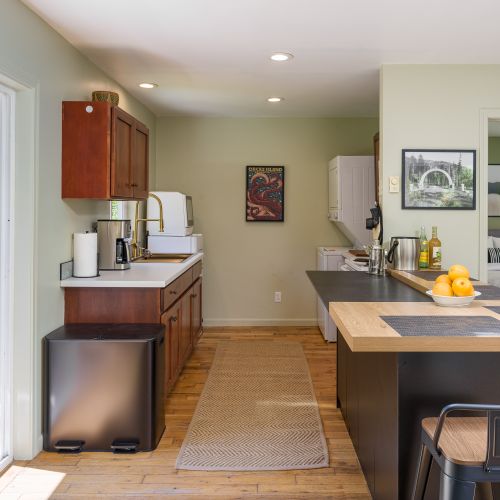 Spacious kitchen with island seating and seamless access to the outdoor deck.