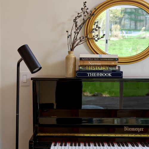 The upright piano in the music room.