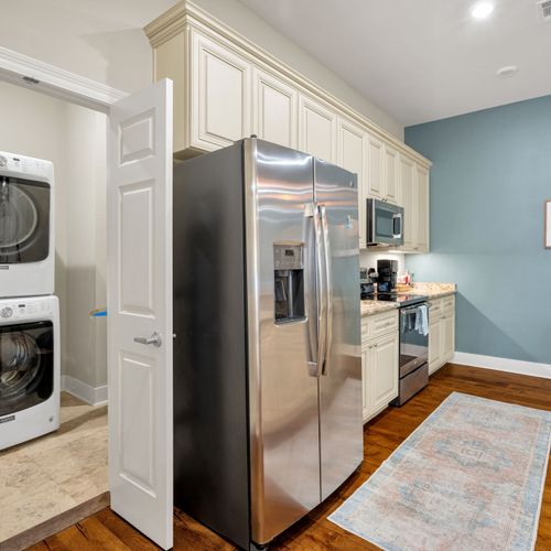 Stainless kitchen with laundry tucked nearby