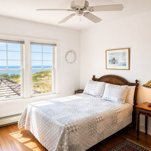 BEDROOM #2 (SECOND FLOOR):  Gorgeous second floor bedroom with a queen bed and incredible views of Lake Michigan and the Frankfort Lighthouse!