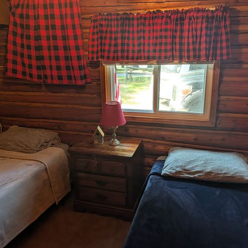 BEDROOM #2:  Features 2 twin size beds, nightstand, lamp, closet, dresser, and luggage stand