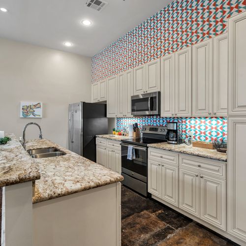 Colorful geometric backsplash in a chef-ready kitchen