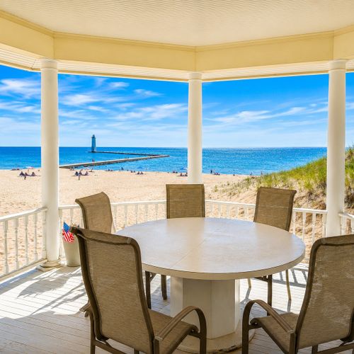 OVERVIEW:  The incredible view of Frankfort Beach, the pier, and the Frankfort Lighthouse from the back porch