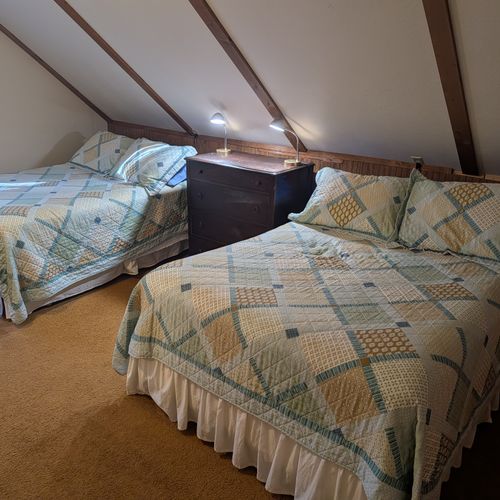LOFT (SECOND FLOOR):  The home has a large upstairs open loft area that includes 3 full-size beds and a twin bed, thus sleeping up to 7 people in the loft area.