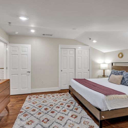 Roomy bedroom with double closets and rug