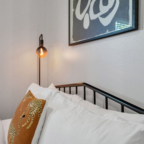 Curl up w/ a book under the warm glow of the wall lamp in this cozy bedroom nook