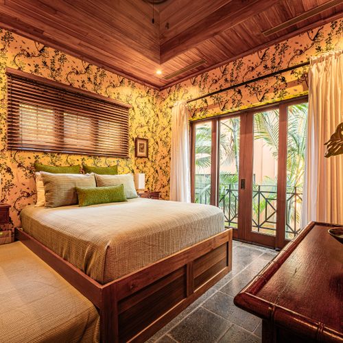King size bedroom with elegant coastal decor and natural light at a luxury Playa Langosta vacation rental in Tamarindo, Costa Rica. Comfortable retreat ideal for relaxing beach vacations, extended stays, and tropical living.