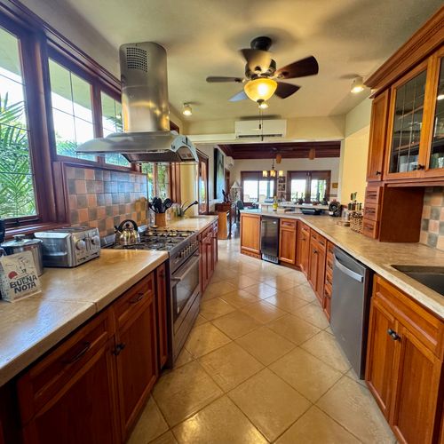 The custom kitchen is right next to the dining table and living area for family cooking but far enough for a private chef