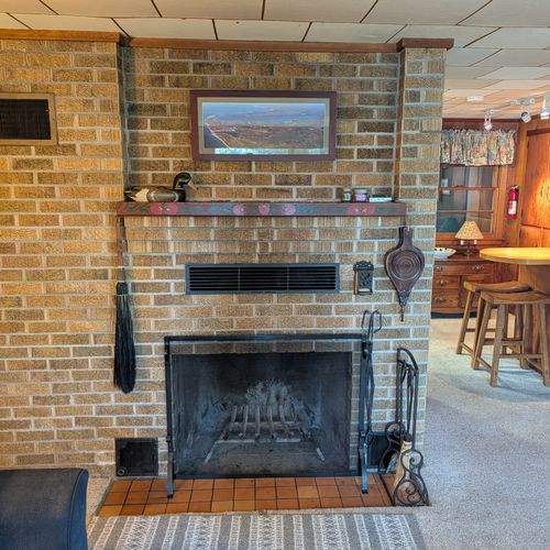 MAIN LIVING ROOM (FIRST FLOOR):  The home has a large, cozy, and comfortable living room on the main floor.  Note that the wood fireplace is available for guest usage.
