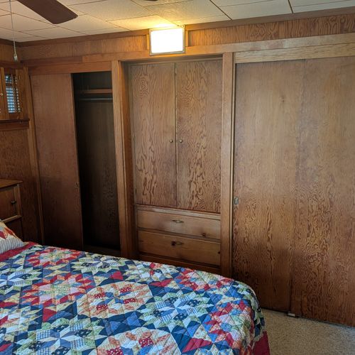 BEDROOM #1 (MAIN FLOOR):  Features a great view of Crystal Lake, queen-size bed, closet, dresser, and a televison.