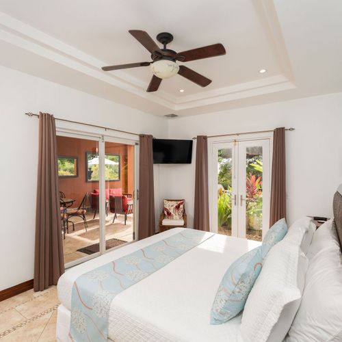 Spacious master suite with walk-in closet and direct balcony access at luxury Playa Langosta condo in Tamarindo, Costa Rica. Open layout, natural light, ocean breeze, and steps from the beach. Ideal for relaxing getaways and beachfront living.