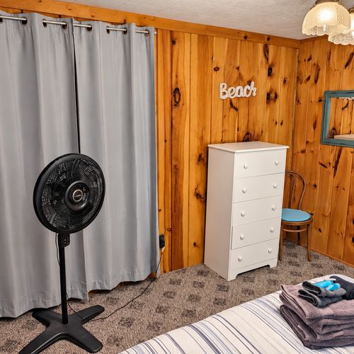 BEDROOM #1:   Features a queen-size bed, nightstands, lamp, dresser, closet, and chair.