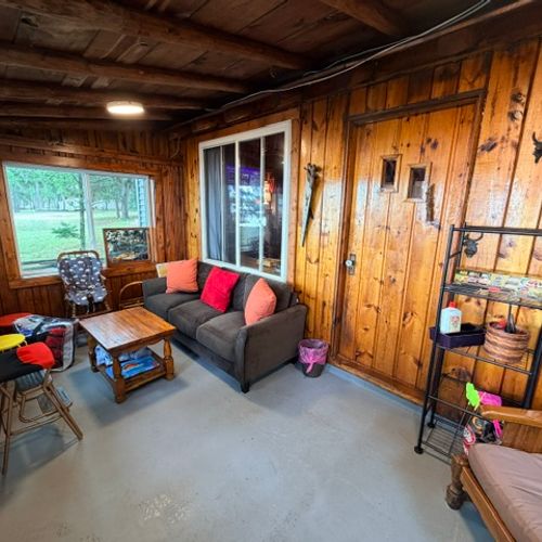 SUNROOM:  The home has a lovely sunroom with lots of seating and a great view of Van Etten Lake.