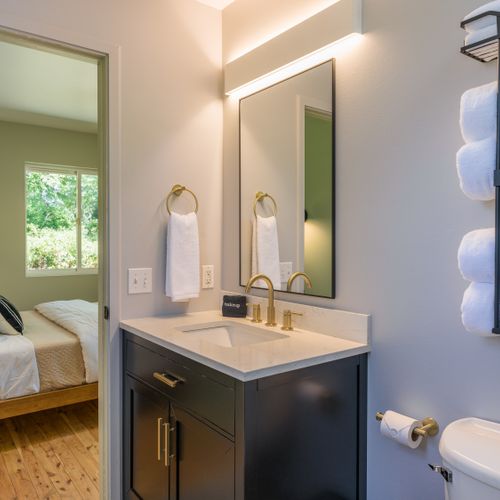 Bright and thoughtfully designed ensuite bathroom with upscale finishes and plush towels.