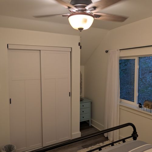 BEDROOM #1 (SECOND FLOOR):  Features a queen-size bed, nightstands, lamps, dresser, mirror, closet, and ceiling fan.