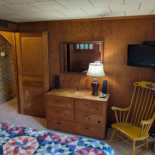 BEDROOM #1 (MAIN FLOOR):  Features a great view of Crystal Lake, queen-size bed, closet, dresser, and a televison.