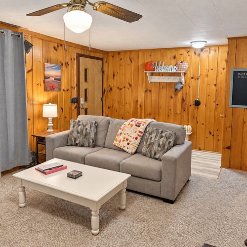OVERVIEW:  The home has a comfy and relaxing living room with a sofa, chair coffee table, and television.  (Note that the wood fireplace in the living room is not available for guest usage.)