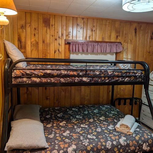 BEDROOM #2: Includes a twin on full bunk bed, a dresser, and a mirror.