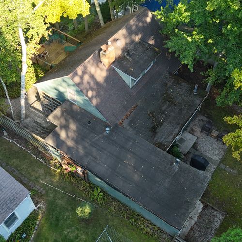 EXTERIOR:  Aerial view of the property.  The front yard is at the right of the photo and the backyard is at the left (with the backyard deck visible in the photo).