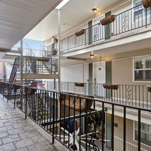 Breezy covered walkway leading to your unit — a peaceful arrival every time.