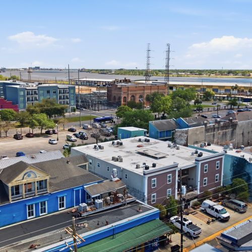 Rooftop perspective capturing the city streets meeting the riverfront.