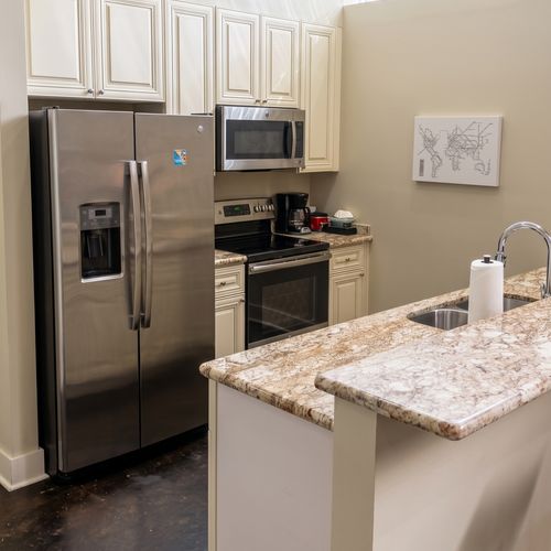 Fully equipped kitchen with stainless steel appliances and generous counter space