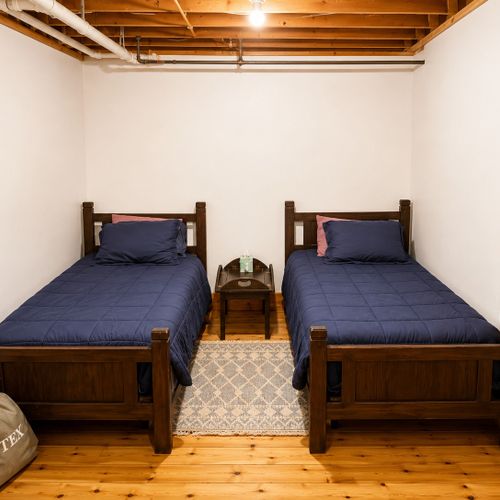 BEDROOM #6 (BASEMENT):  There is a small bedroom with 2 twin beds in the basement.